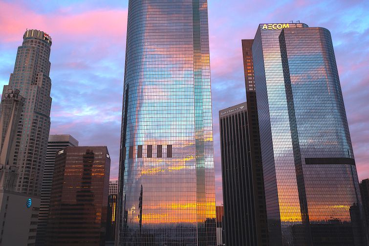 The City National Bank and AECOM buildings reflect clouds at sunrise as another in a series of atmospheric river storms hit California in January 2023. The U.S. Bank, CBRE and Bank of America buildings are visible behind them.