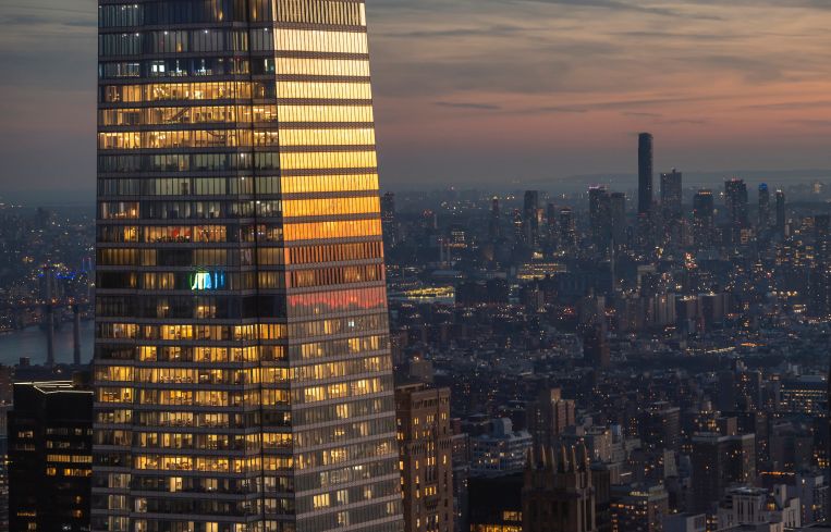 The setting sun is reflected in the windows of One Vanderbilt, the second tallest office building in New York City in December 2022.