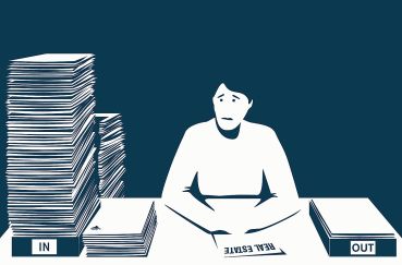 A figure looks in anguish at a massive stack of papers.