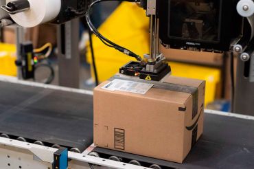 A package is labeled at a SLAM, or scan, label, apply and manifest during a tour of Amazon's Fulfillment Center.