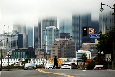Rain clouds shroud the skyline of Downtown Los Angeles on a rainy Wednesday afternoon in January 2023.