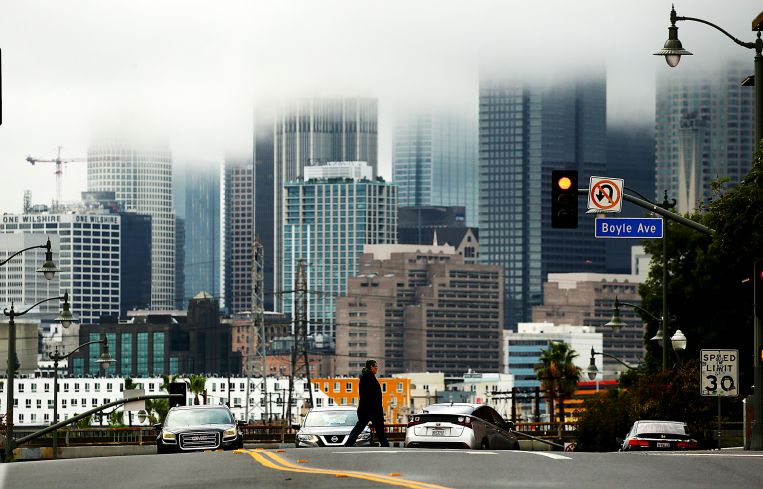 Rain clouds shroud the skyline of Downtown Los Angeles on a rainy Wednesday afternoon in January 2023.
