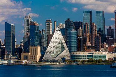 Midtown Skyline of Manhattan, New York shows VIA 57 West at 625 West 57th St. in Hells Kitchen Pyramid and Hudson River, architecture by Bjarke Ingelss Tetrahedron.
