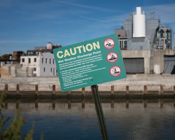 A sign urges caution due to the possible presence of untreated sewage by the Gowanus canal in Brooklyn.