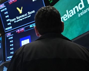 A trader watches stock prices on the New York Stock Exchange.