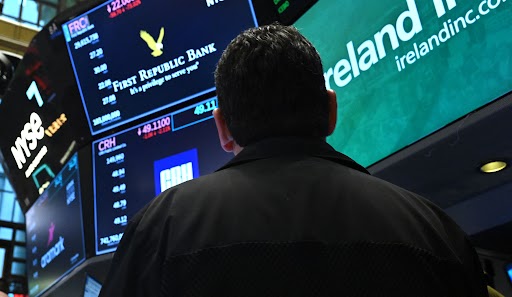 A trader watches stock prices on the New York Stock Exchange.