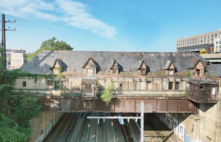 The rear of the train station is being repaired and renovated, but it requires a scaffold to protect the Amtrak tracks underneath the building.