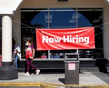 A Now Hiring sign hangs in front of a Winn-Dixie grocery store on December 03, 2021 in Miami, Florida.