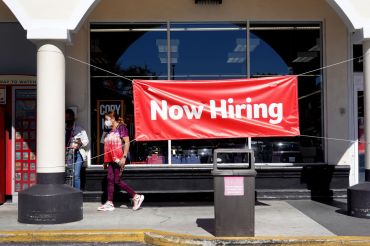 A Now Hiring sign hangs in front of a Winn-Dixie grocery store on December 03, 2021 in Miami, Florida.