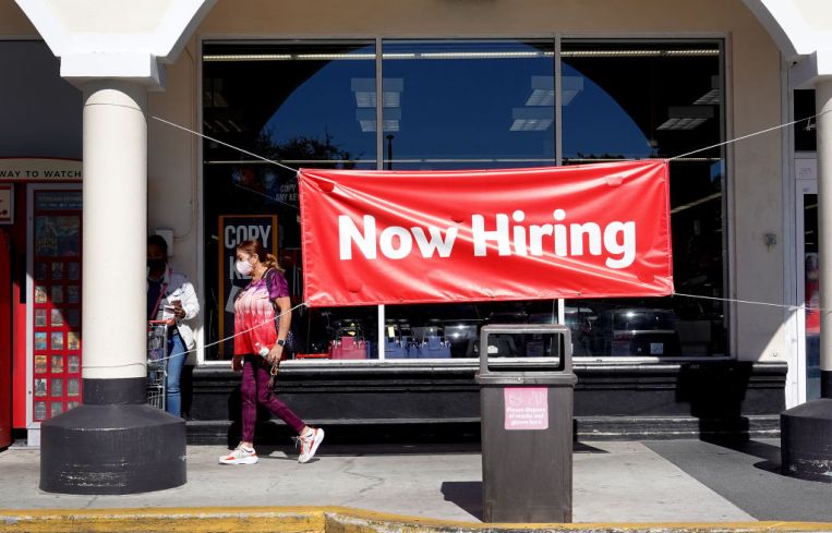 A Now Hiring sign hangs in front of a Winn-Dixie grocery store on December 03, 2021 in Miami, Florida.