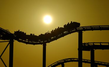 The sun sets behind a roller coaster on the Santa Monica Pier on April 15.
