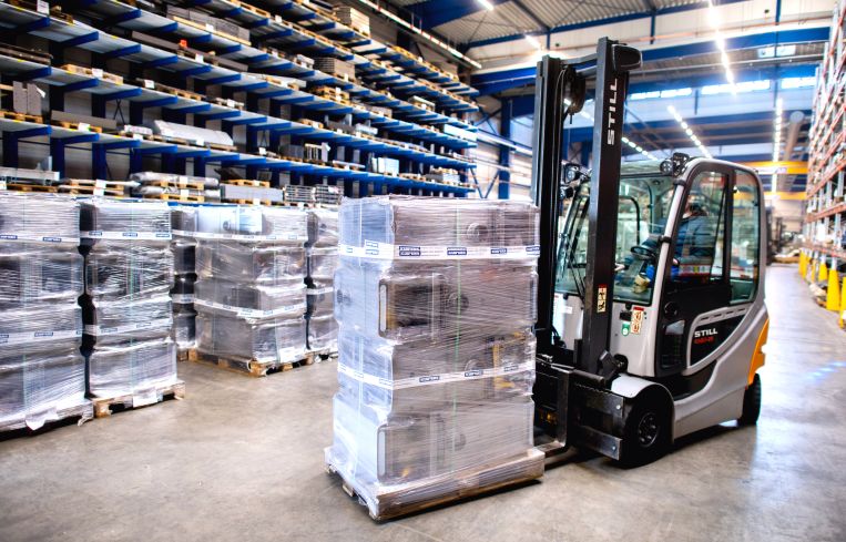Forklift truck stands in a warehouse.
