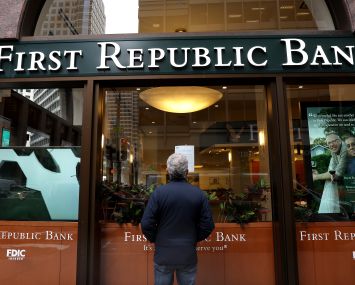 A passerby stops to read a posted announcement from the FDIC about the seizure of First Republic Bank and sale to JPMorgan Chase on May 01, 2023