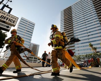 On the morning of January 29, 2020, firefighters prepared hoses at a large blaze at Barrington Plaza, a 25-story Westside residential building in Los Angeles.