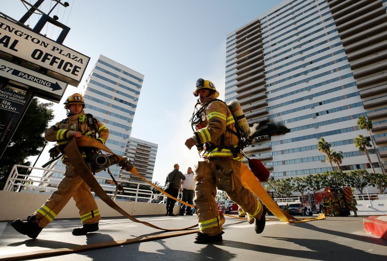 On the morning of January 29, 2020, firefighters prepared hoses at a large blaze at Barrington Plaza, a 25-story Westside residential building in Los Angeles.