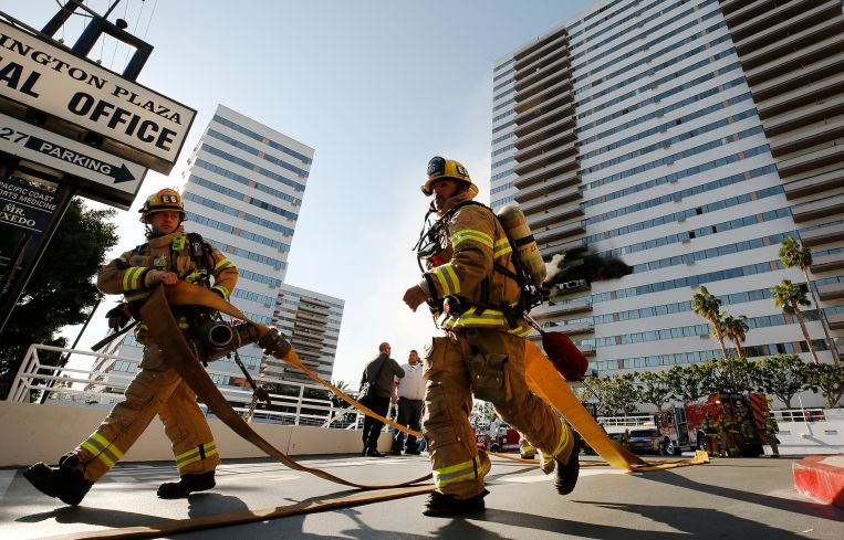 On the morning of January 29, 2020, firefighters prepared hoses at a large blaze at Barrington Plaza, a 25-story Westside residential building in Los Angeles.