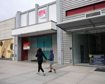 Pedestrians walk past vacant retail store fronts for lease along the Third Street Promenade in Santa Monica on March 20, 2023.