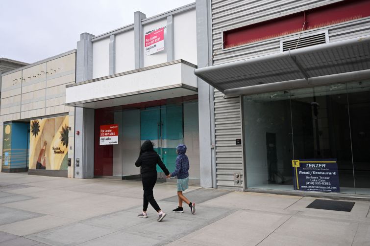 Pedestrians walk past vacant retail store fronts for lease along the Third Street Promenade in Santa Monica on March 20, 2023.