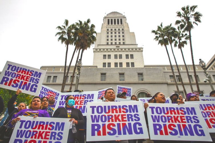 Unions at press conference held by Los Angeles City Councilman Curren Price to announce a motion that would raise the wages for tourism workers to $25 an hour, on the steps of City Hall in April 2023.