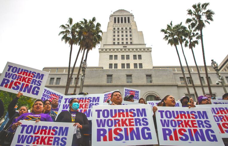 Unions at press conference held by Los Angeles City Councilman Curren Price to announce a motion that would raise the wages for tourism workers to $25 an hour, on the steps of City Hall in April 2023.