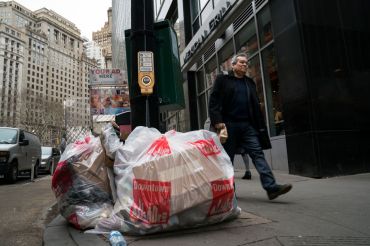 New York City's sanitation department wants to get trash bags off the sidewalks and into containers. But it may not be able to implement the containers in Lower Manhattan and Midtown. 