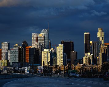 Clouds hover in the background of downtown Los Angeles skyline.