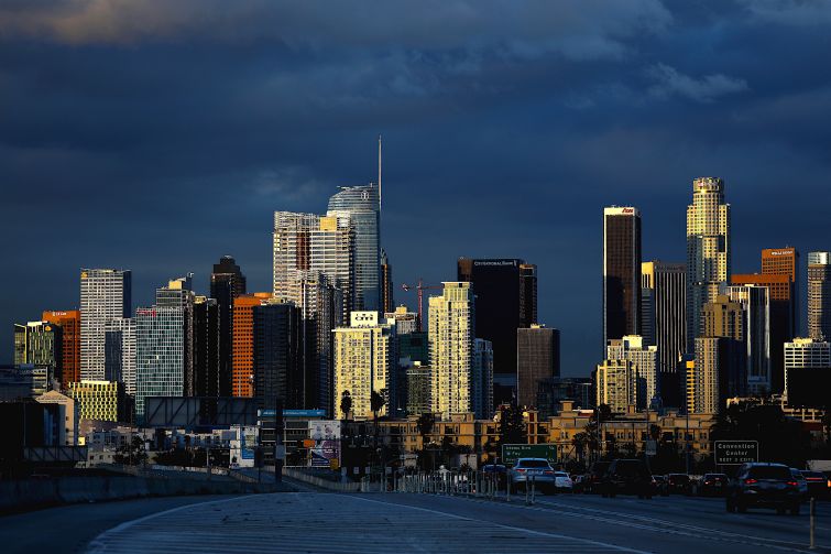 Clouds hover in the background of downtown Los Angeles skyline.