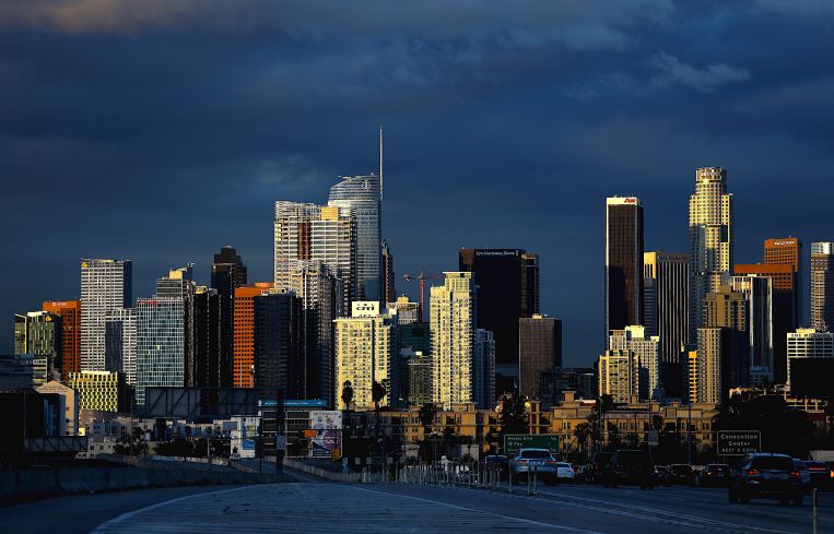 Clouds hover in the background of downtown Los Angeles skyline.