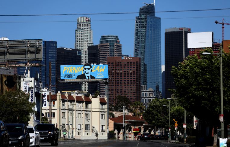 The 33-story copper-colored L.A. Care building, center, is set to be converted into a multifamily property.