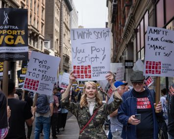 Writers Guild of America members march on a picket line in front of Netflix offices in New York.