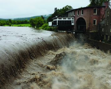 Heavy rain sends mud and debris down the Ottauquechee River in Vermont in July.