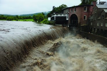 Heavy rain sends mud and debris down the Ottauquechee River in Vermont in July.