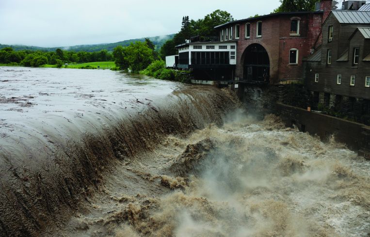 Rushing water overtaking property.