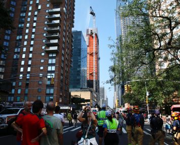 Firefighters battle a fire on a construction crane in New York, on July 26, 2023.