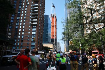 Firefighters battle a fire on a construction crane in New York, on July 26, 2023. 