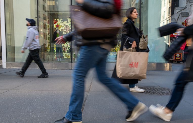 People walk along Fifth Avenue.