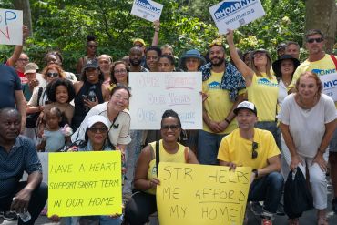 Airbnb hosts rally against the new registration rules in June at City Hall.
