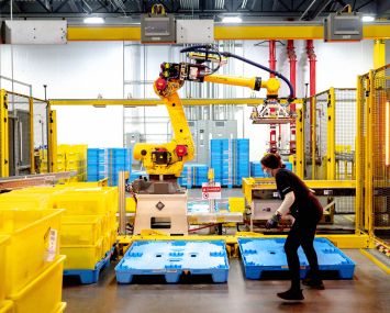 A robot sorts and stacks bins at Amazon fulfillment center in Eastvale, Calif.