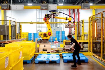 A robot sorts and stacks bins at Amazon fulfillment center in Eastvale, Calif.