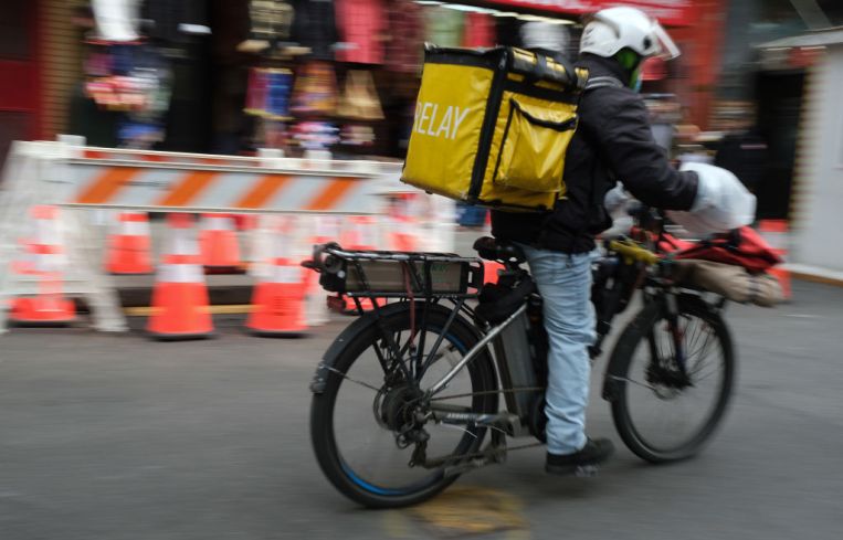 A man in riding an e-bike