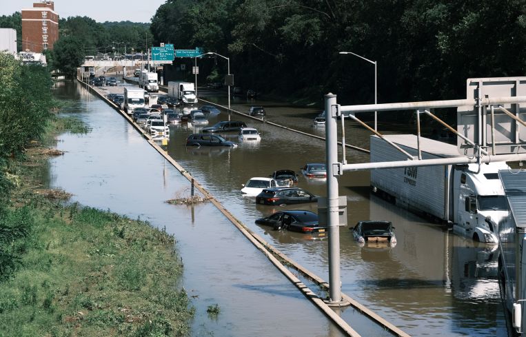 Cars sit abandoned on the flooded Major Deegan Expressway in the Bronx