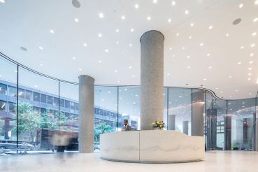 The new lobby at 767 Third Avenue has curved, floor to ceiling glass panels. 