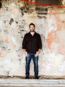 A man standing in front of a wall.