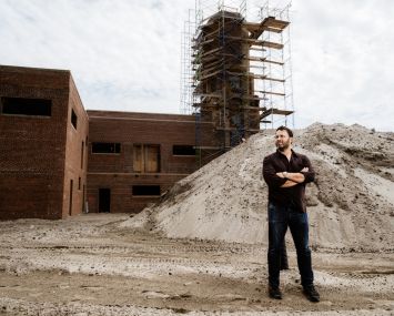 A man standing at a construction site.
