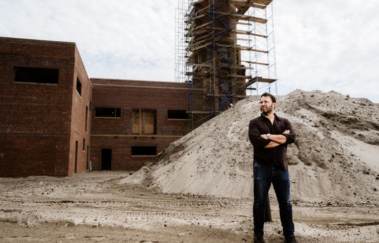 A man standing at a construction site.