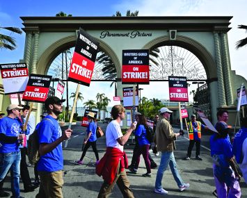 People striking outside a film studio.