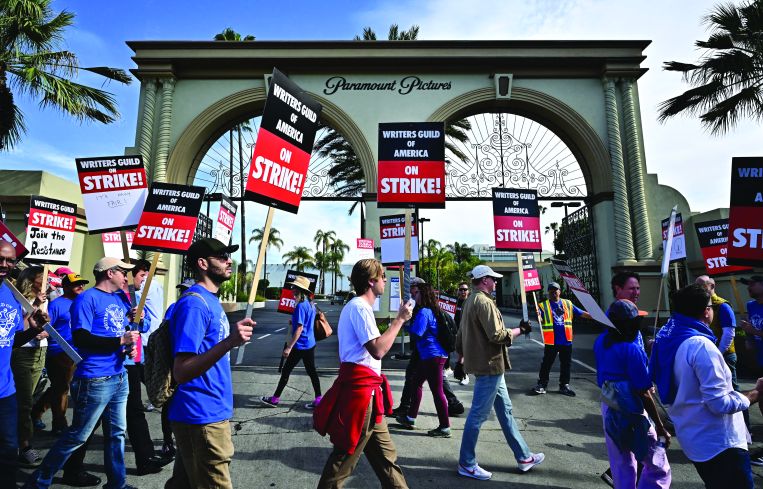 People striking outside a film studio.