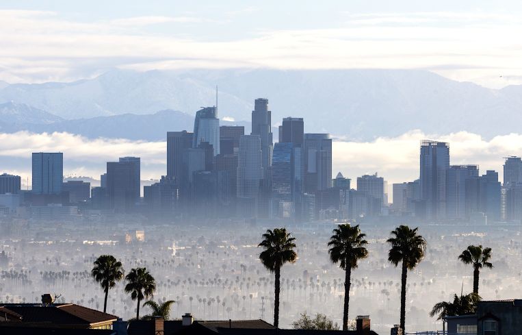 Clouds hover in the background of downtown Los Angeles skyline.