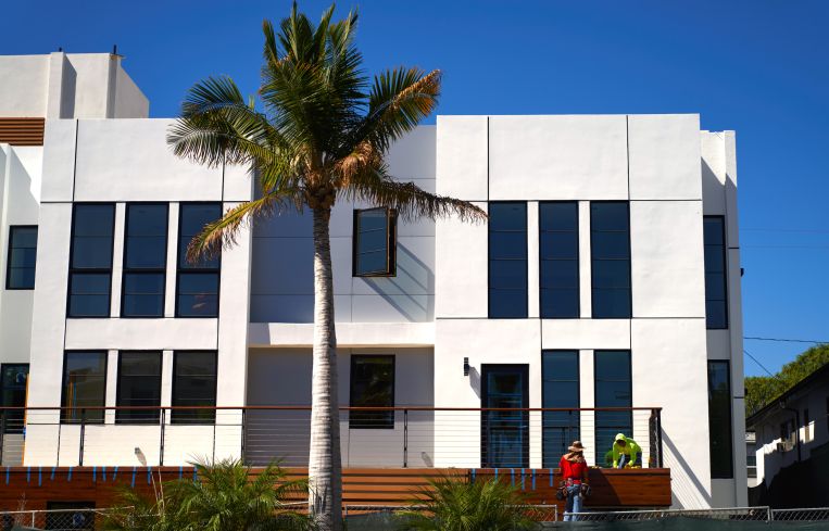 A construction crew works to complete a nearly finished project in Los Angeles.