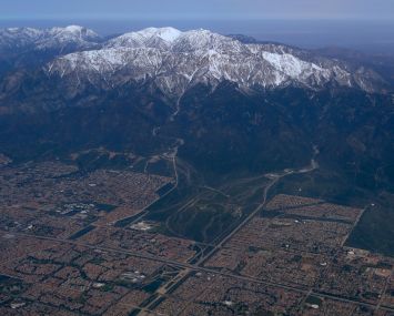 The snow covered San Gabriel Mountains are seen from a United Airlines airplane over San Bernardino County as it makes its way to Los Angeles in April.
